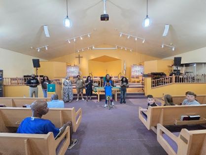 Children and adults gathered at the front of the sanctuary — VBS Day 1
